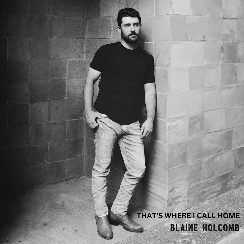 Blaine Holcomb poses in front of cinder block wall for the album cover of That's Where I Call Home"