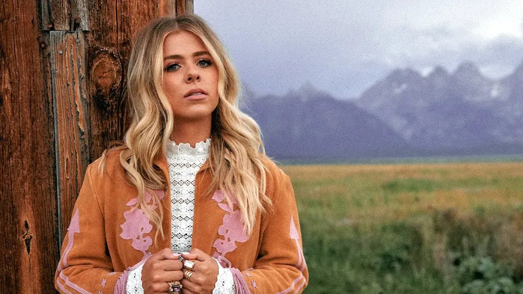 Anne Wilson stands in front of mountains